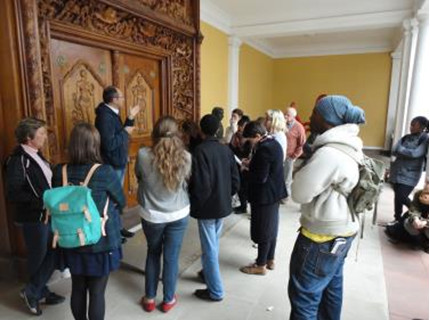 Click the image for a view of: Hayden Proud discussing the Liberman doors and their history with the students.